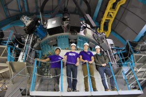 Marlowe, Hockett, Dr. Brad Barlow, assistant professor of astrophysics, and Filik stand next to the 4.2-meter SOAR telescope.