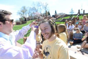 Senior Matt Jakubowski makes the initial cut on junior Kyler Bradley’s locks.