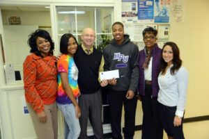 The Diversity Club donates a check of $850 dollars to Open Door Ministries.
