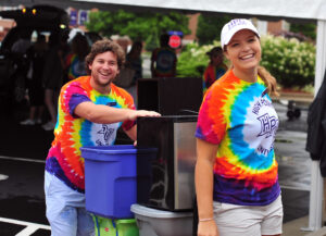 HPU students Nick Fisher and Sara Foster volunteer to unload the vehicle of a freshman and move items to their room. 
