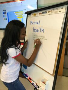 Pictured is Shirley Garrett discussing mental health during a presentation