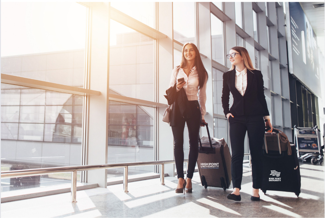 High Point university students with luggage in airport