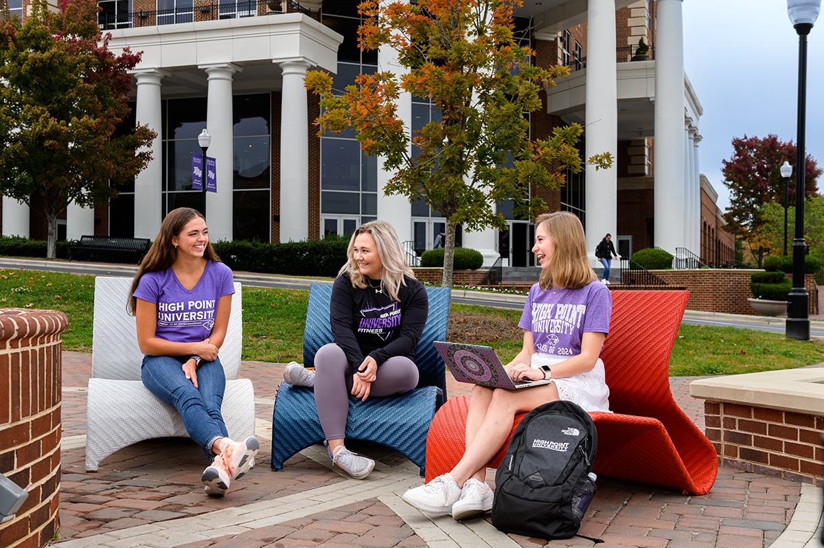Emerson Hecker, left, is shown laughing with friends on HPU's campus.