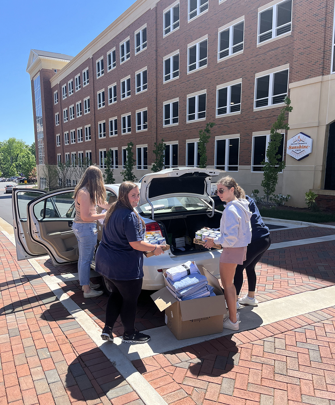 Pictured from left on the HPU campus loading donations for Open Door Ministries are Kathleen Harb, Morgan Rooks, Gena Ciampa and Jessica Robles. Other students who assisted but are not pictured are Mykala Woods and Hannah Corns.