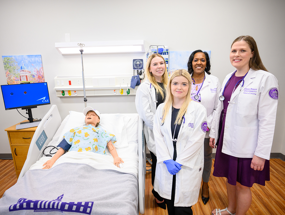 Pictured from left are Class of 2024 nursing alumnae Piper Dillon and Kellie Brewer with Dr. Racquel Ingram, founding dean, and Dr. Rachel Phelps.