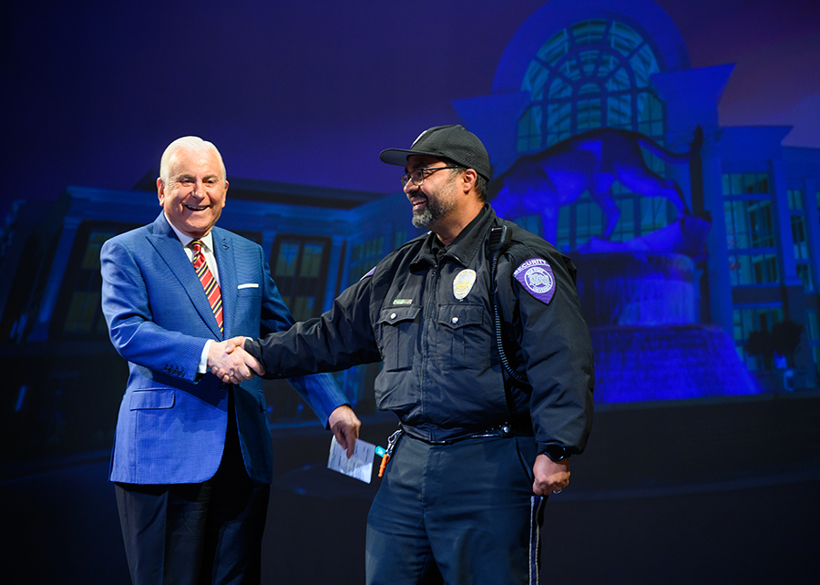Qubein congratulates Malcolms Lovo, a security officer for the HPU campus police and security team who received the Kahn Extraordinary Staff Award.