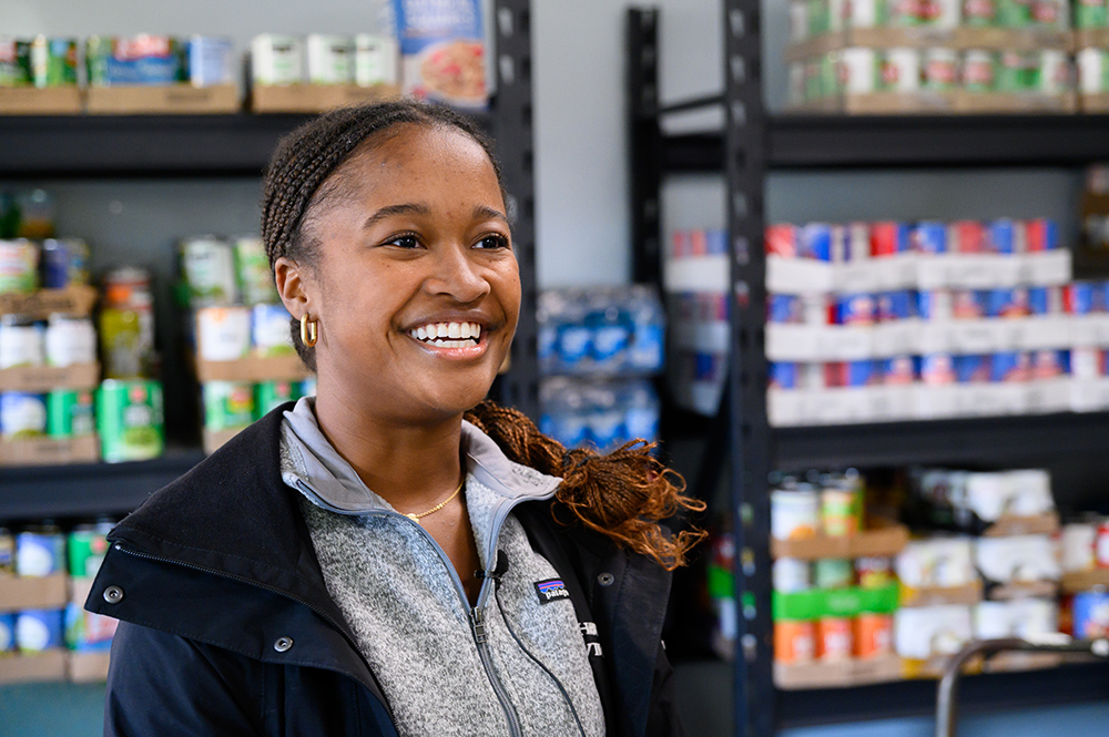 SGA President Hannah Parson, a senior political science major from Orlando, Florida, answers questions about the food donation efforts while inside Open Door Ministries’ food pantry.
