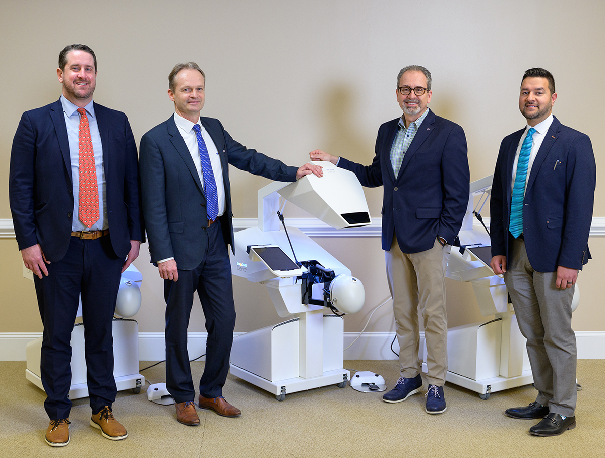 ) Pictured with the dental simulation units are, from left, Dr. Kevin Cain, senior associate dean for administration and finance; Karel van Gelder, SIMtoCARE CEO and founder; Dr. Scott De Rossi, founding dean; and Dr. Ali Shazib, associate professor and assistant dean/chief clinical officer. 