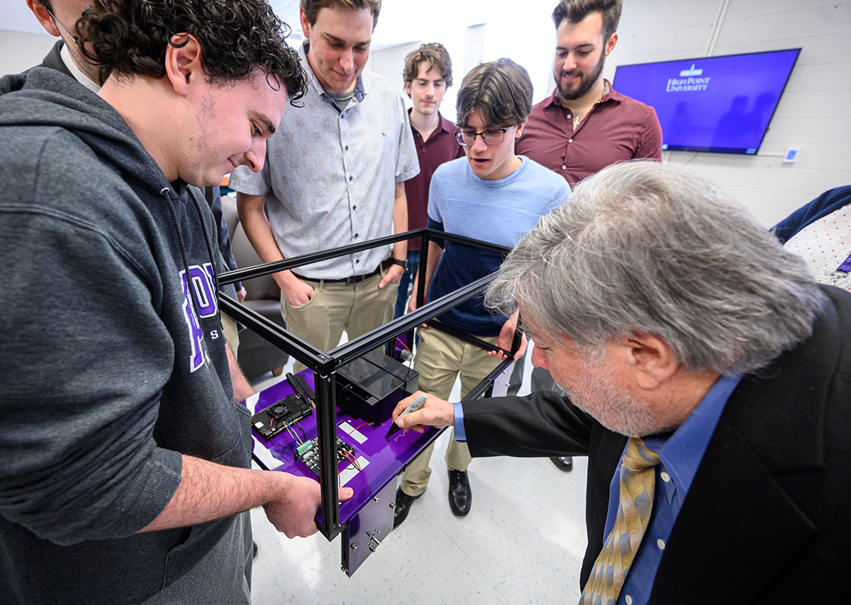Steve Wozniak reviews the HPU Robotic Team's designs for a lunar rover.