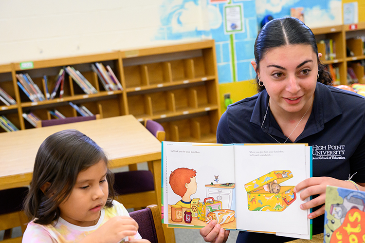 Tori Sebastiano, a middle school education major from Lebanon, New Jersey, reads with kindergarten students. 