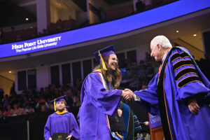 A graduate shook HPU President Nido Qubein’s hand while walking across the stage at Commencement.