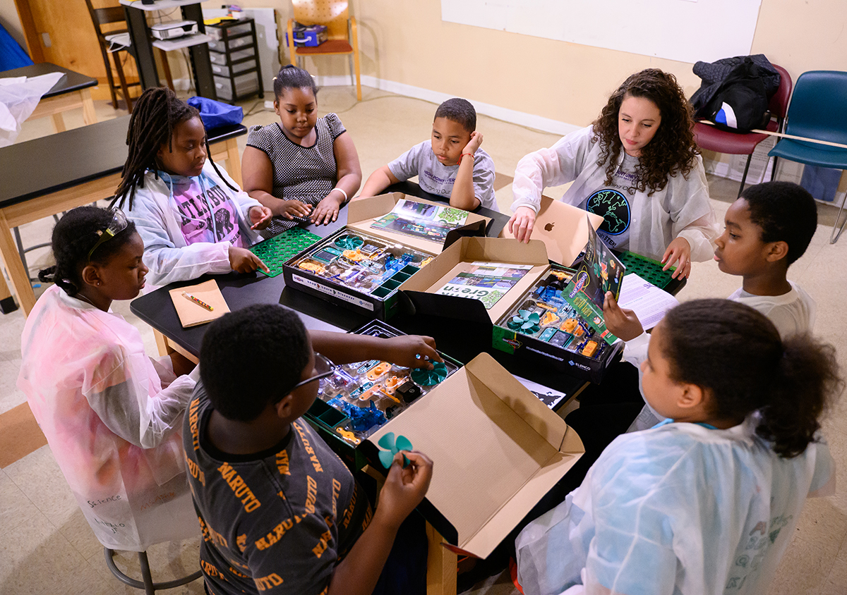 Pictured at top right is Ashley Cluff, an HPU student and PREPARE participant, leading fifth-grade students in a STEM Camp activity focused on renewable energy.
