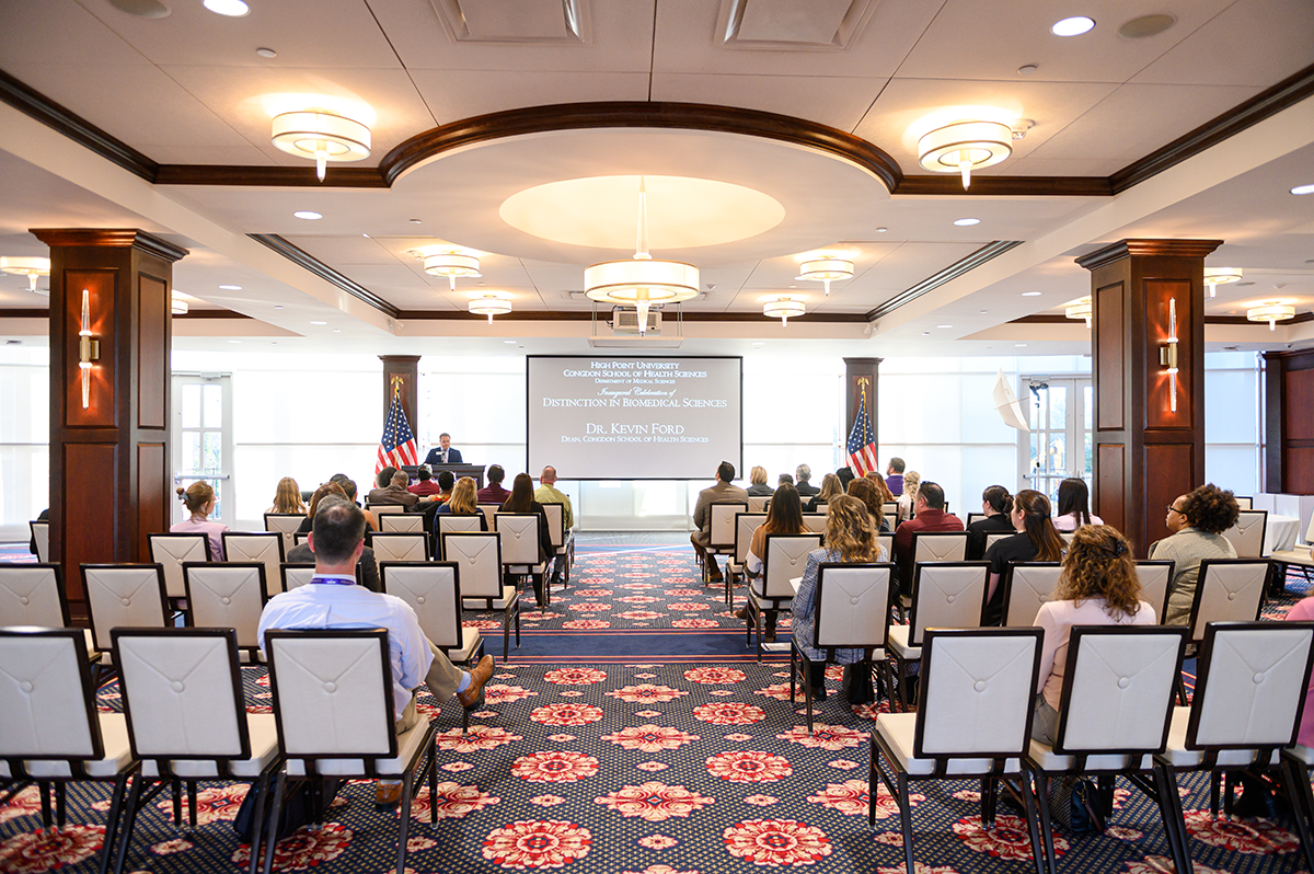 HPU Biomedical White Coat Ceremony, the audience listens to one of the speakers at the event.