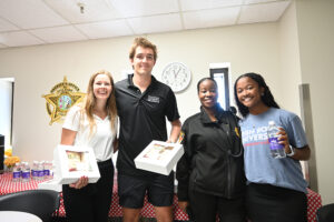Pictured at left is High Point University Student Government Association Vice President Hannah Tameling, Boyle and Parson as they posed with a staff member from the Guilford County Sheriff’s Office.