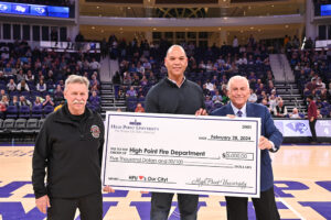 High Point University President Nido Qubein presented a check to the High Point Fire Department.