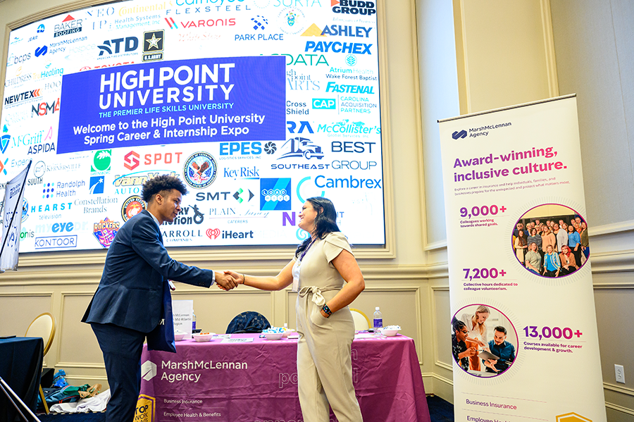 HPU Spring Career Expo, student shakes hands with employer