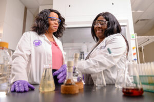 High Point University's Dr. Comfort Boateng , assistant professor of basic pharmaceutical sciences, conducts research with Rebekah Placide in HPU's Fred Wilson School of Pharmacy.